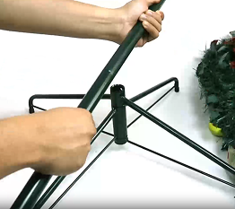Person assembling a metal stand in the background