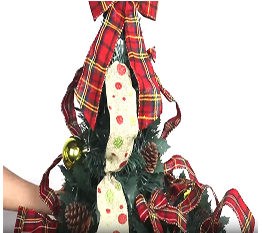 Expanding the decorative Christmas tree with red plaid ribbons and ornaments on a white background