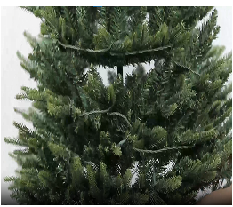 Expanding the artificial Christmas tree in a white background